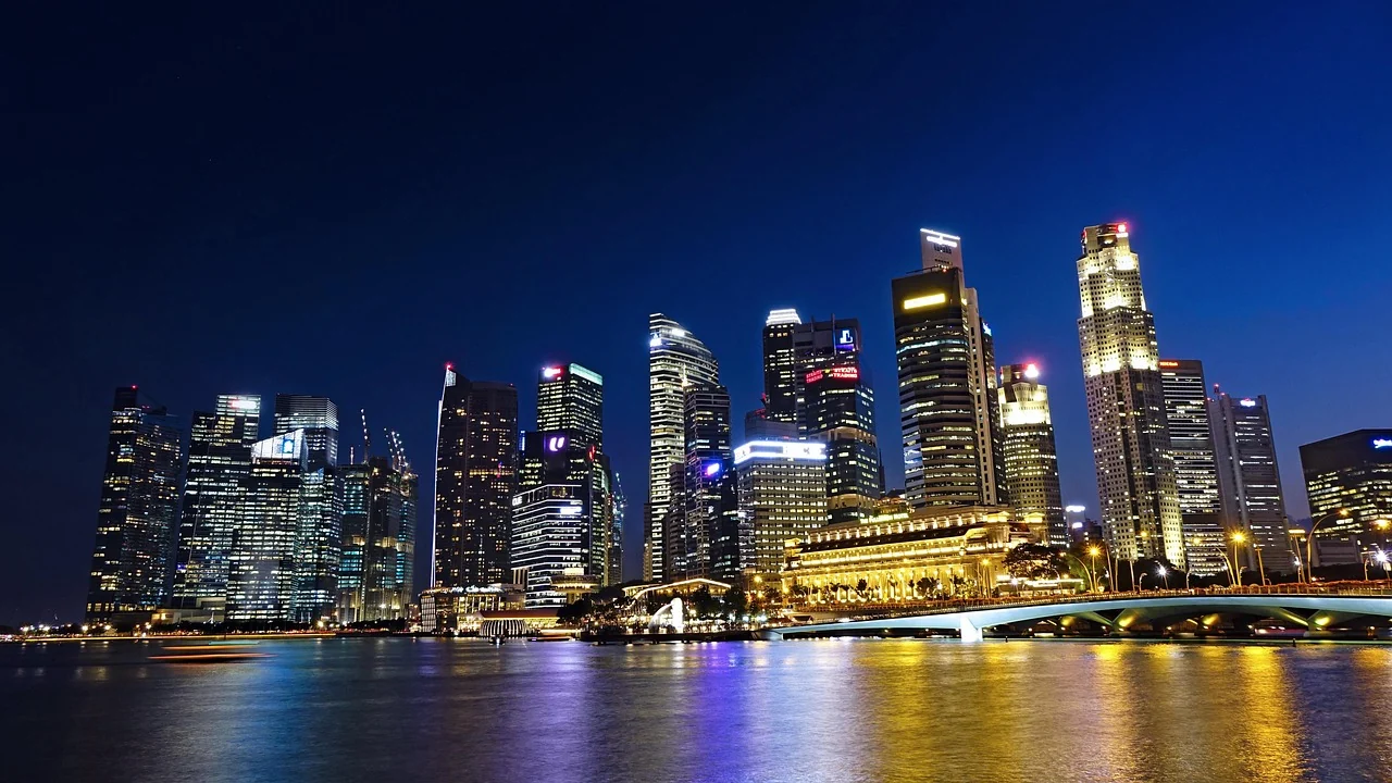 Lit buildings of Singapore reflected in the river at night